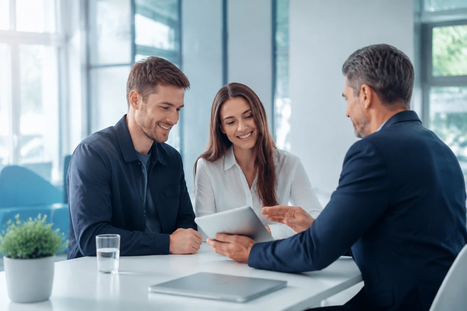 Adviser and a couple discussing options together on a tablet